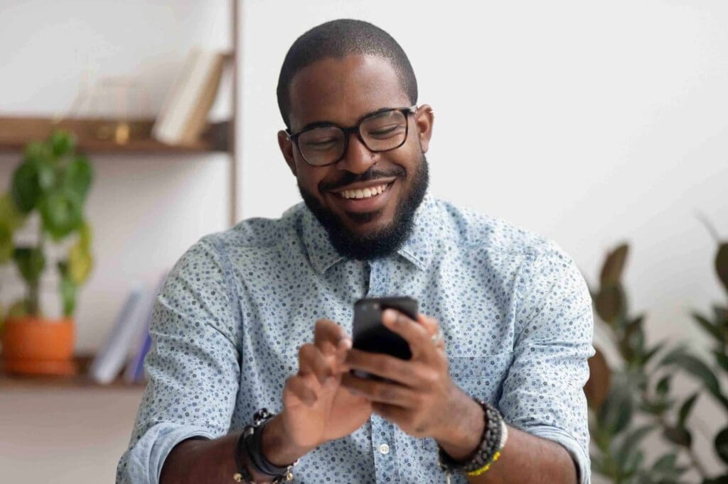 Man in a blue shirt looking at his phone
